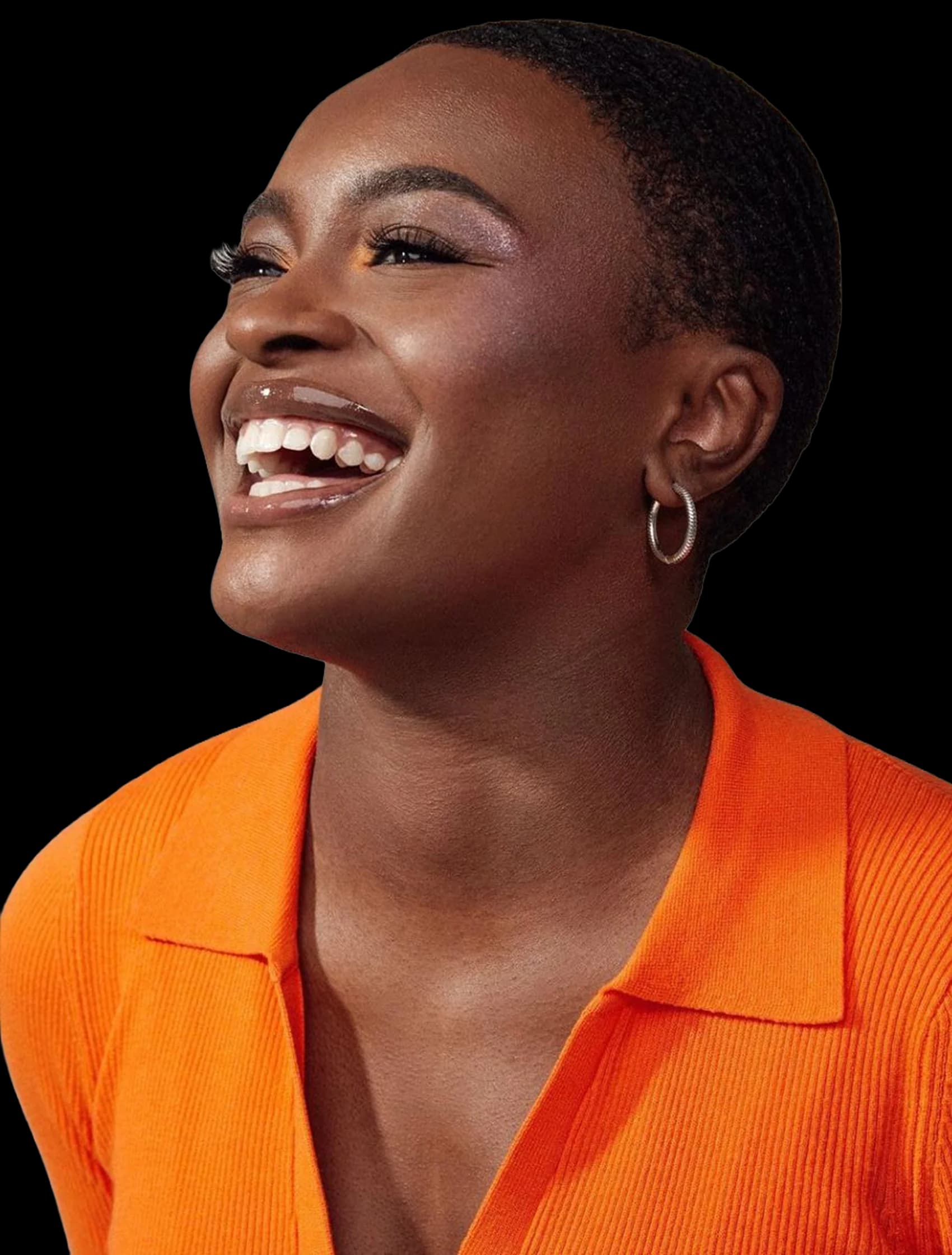 A founder laughing, wearing an orange collared top